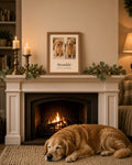 Oak-framed portrait Years Together print centred on a cosy Christmas mantelpiece, showing a golden retriever as a puppy and today with the name Bramble and Since 2014 · Years Together, old dog asleep on the rug below – Example design – your photos are used