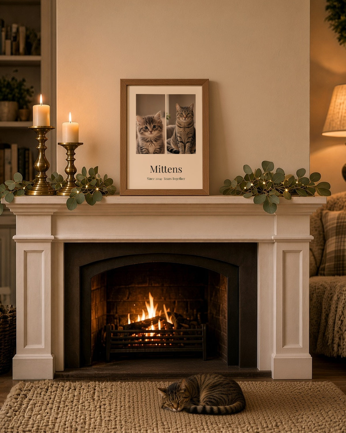 Oak-framed portrait Years Together print on a cosy mantelpiece showing a tabby kitten and the same cat today, named Mittens, Since 2014 · Years Together, with the cat asleep on the rug below – Example design – your photos are used