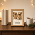 Small 13×18cm oak mini frame on a bedside table beside two paperbacks and a mug of tea, showing a golden retriever as a puppy and today with the name Bramble and Since 2014 · Years Together – Example design – your photos are used