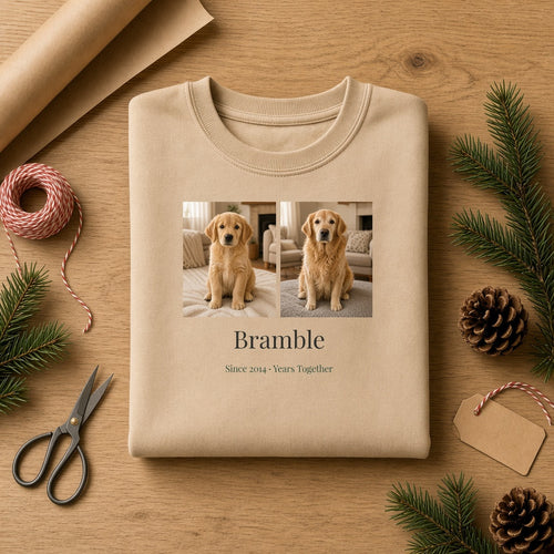 Folded Sand crewneck Years Together sweatshirt with a chest print of a golden retriever as a puppy and today, the name Bramble and Since 2014 · Years Together, on a wooden table with kraft wrapping paper, twine and pine – Example design – your photos are used